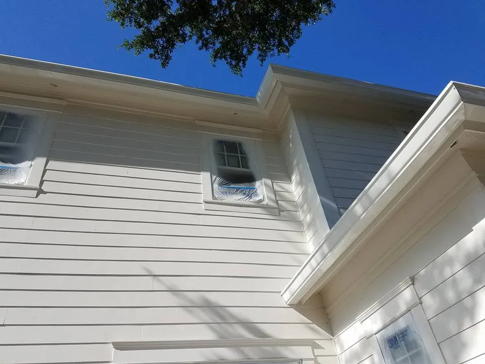 Looking up white lap siding fascia gutter masked windows, Sanford